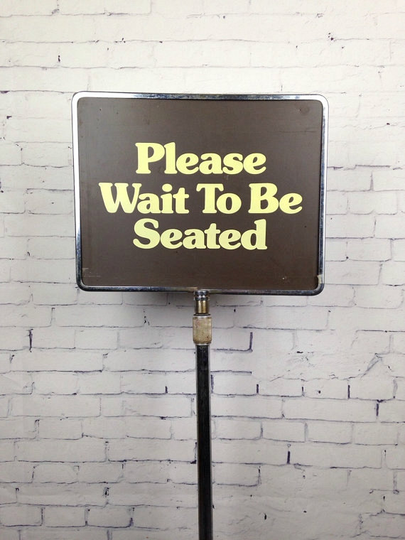 restaurant sign of waiting to be seated
